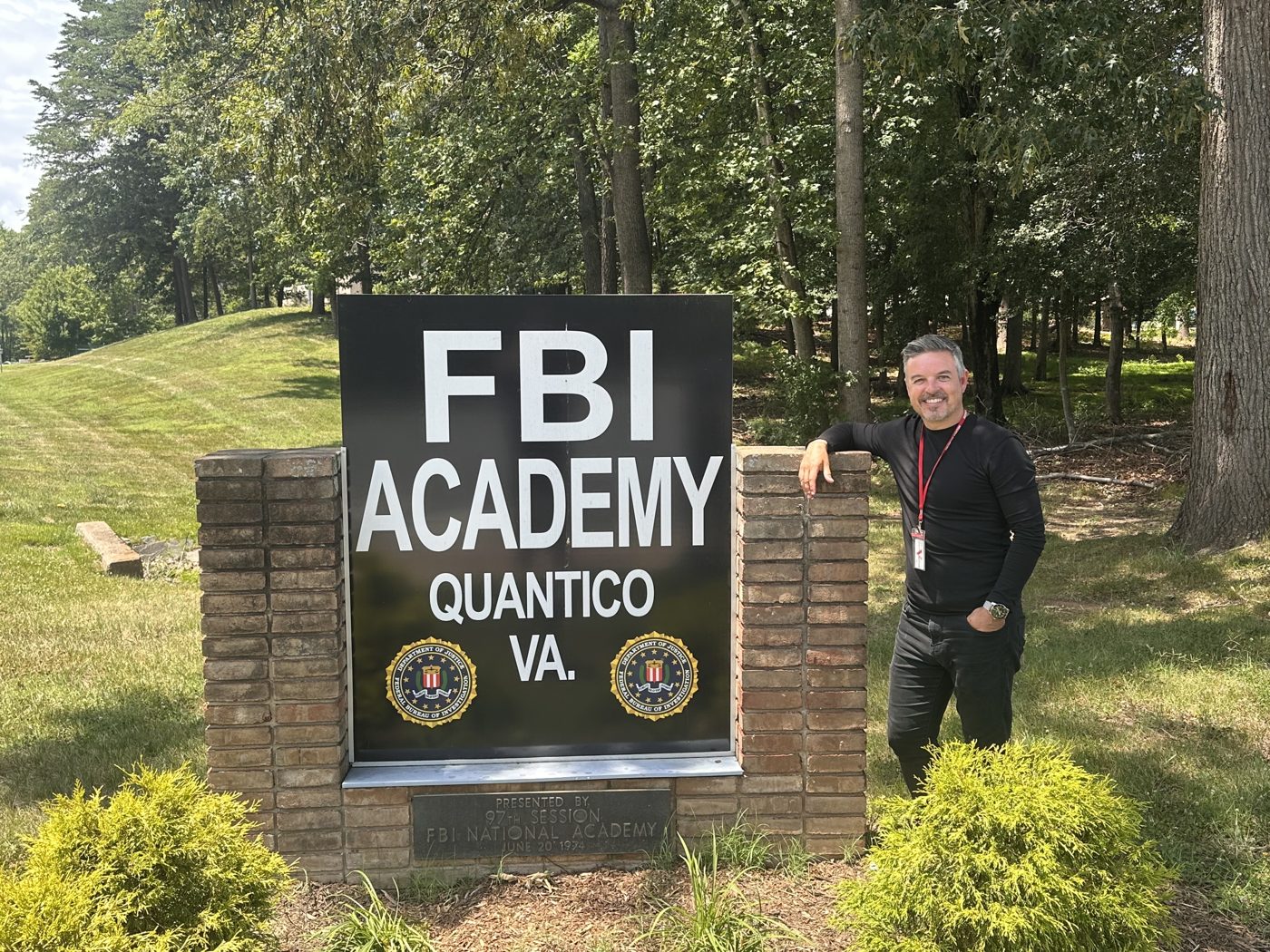 Jamie at the FBI Academy sign, Quantico